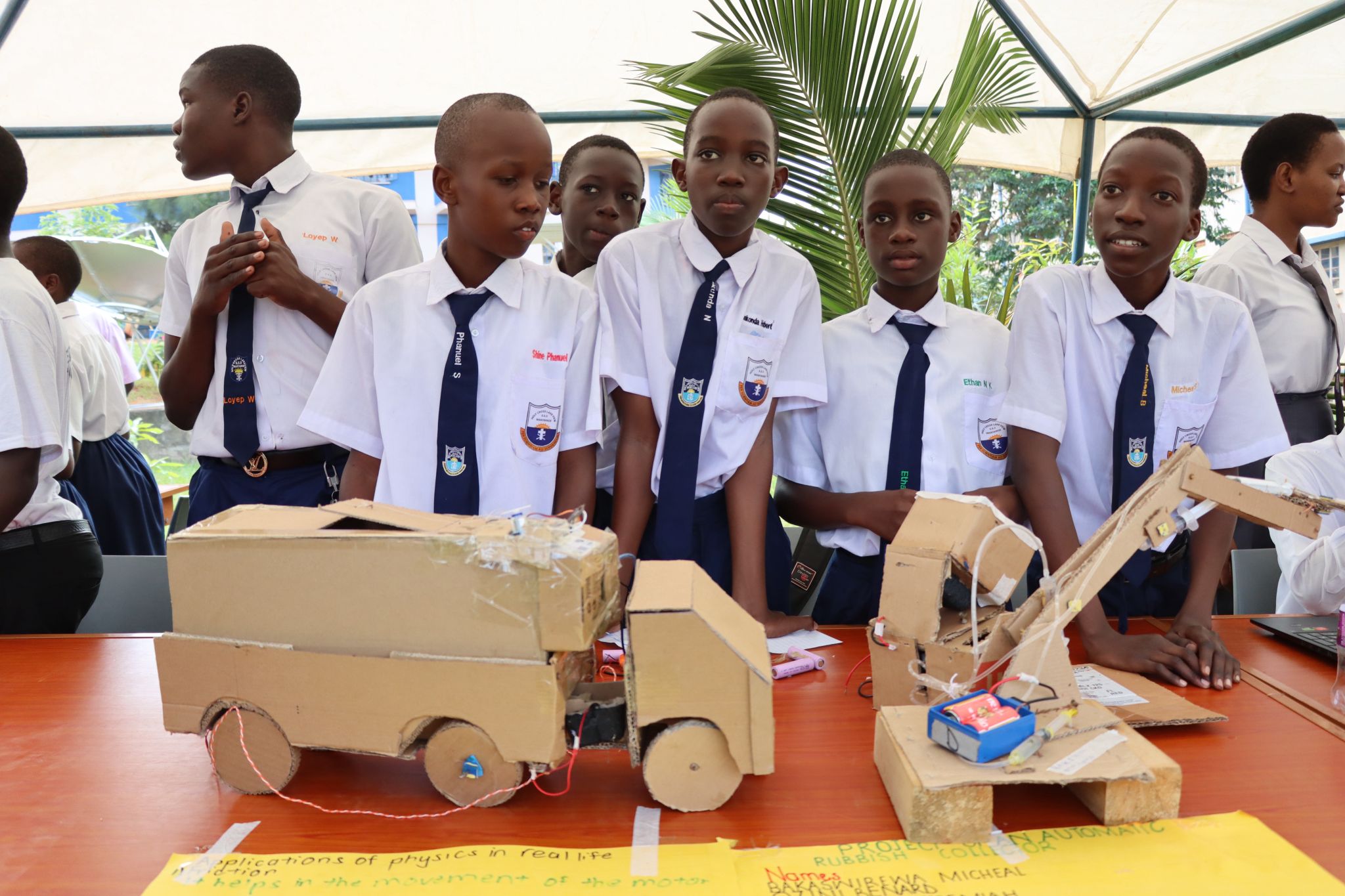 Students presenting electronics and solar experiments at a STEM exhibition
